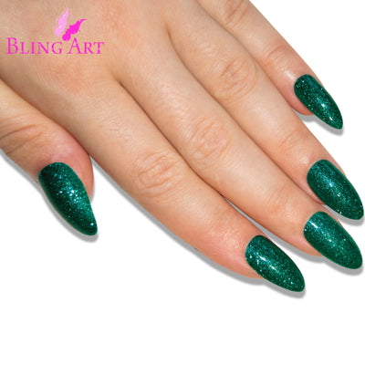Green gel almond stiletto Bling Art press-on nails — worn-hand close-up showing the emerald-green gel coat on long pointed almond stiletto tips. Almond = Stiletto (same shape).