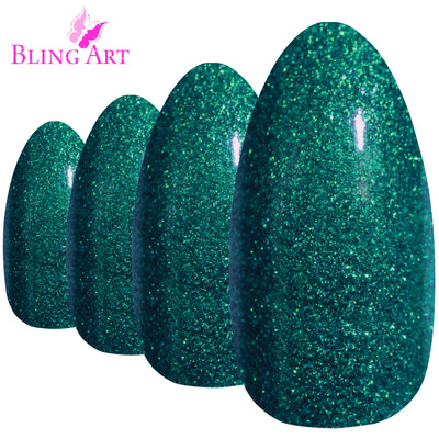 Green gel almond stiletto Bling Art press-on nails — worn-hand close-up showing the emerald-green gel coat on long pointed almond stiletto tips. Almond = Stiletto (same shape).