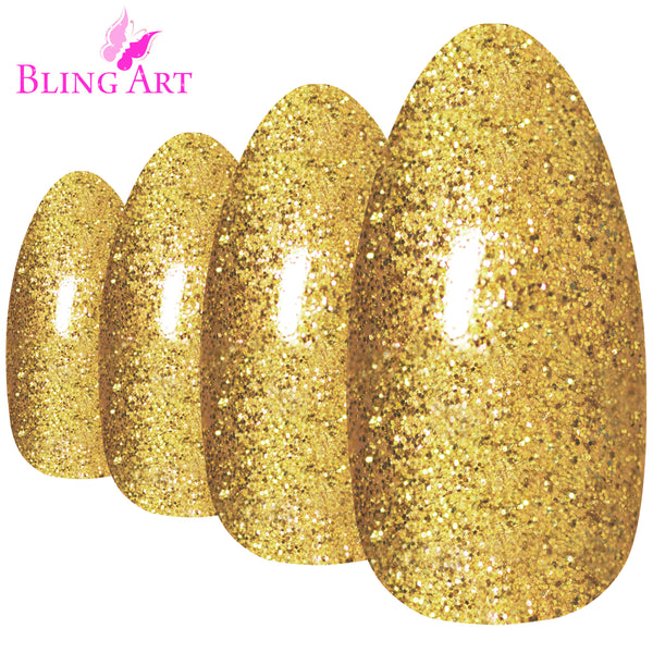 Gold gel almond stiletto Bling Art press-on nails — worn-hand close-up showing the champagne-gold gel coat on long pointed almond stiletto tips. Almond = Stiletto (same shape).