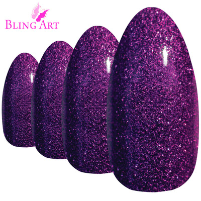 Purple gel almond stiletto Bling Art press-on nails — worn-hand close-up showing the aubergine gel coat on long pointed almond stiletto tips. Almond = Stiletto (same shape).