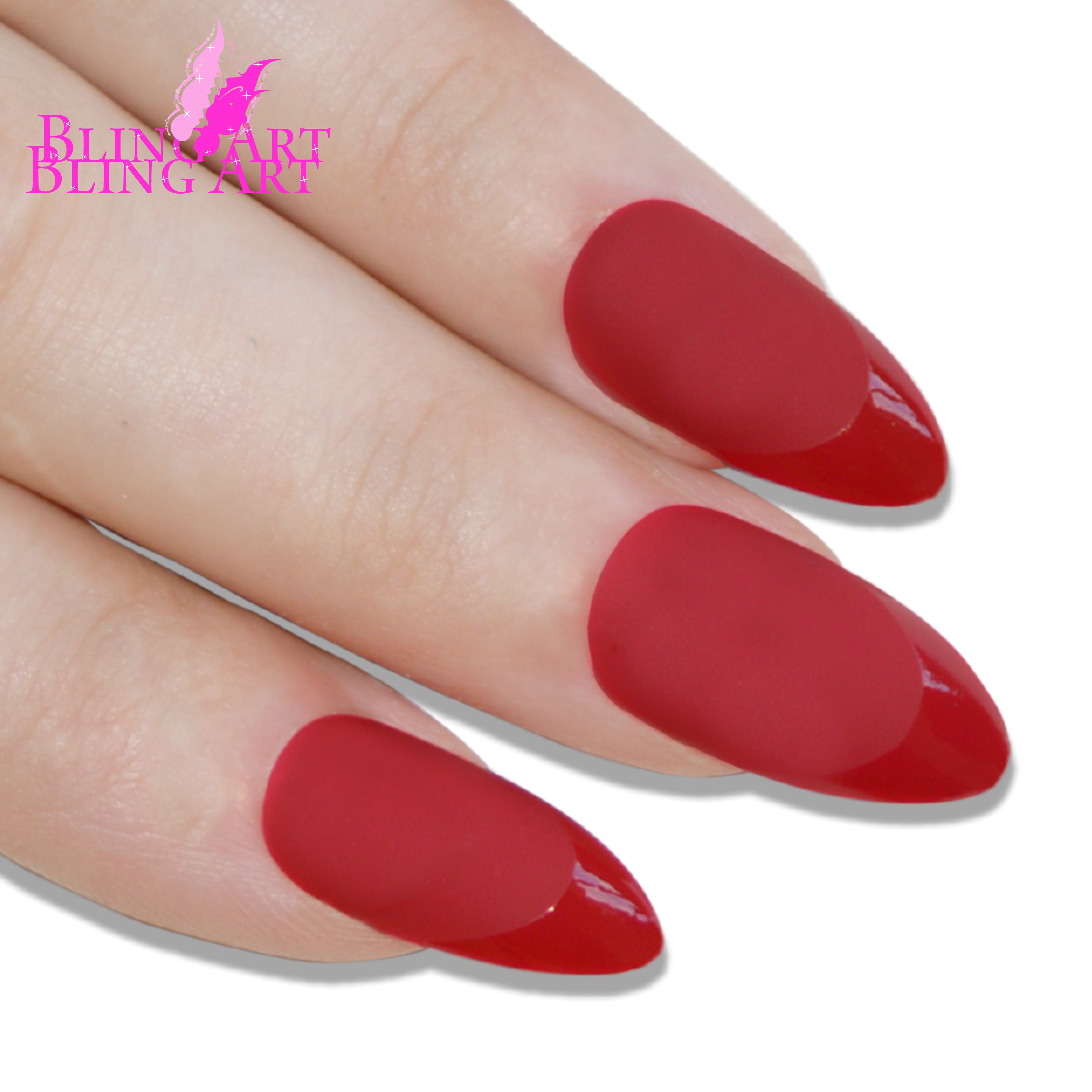 Red matte almond stiletto Bling Art press-on nails — worn-hand close-up showing the bold crimson velvet matte on long pointed almond stiletto tips. Almond = Stiletto (same shape).