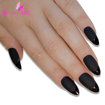 Black matte almond stiletto Bling Art press-on nails — worn-hand close-up showing the jet-black velvet matte on long pointed almond stiletto tips. Almond = Stiletto (same shape).