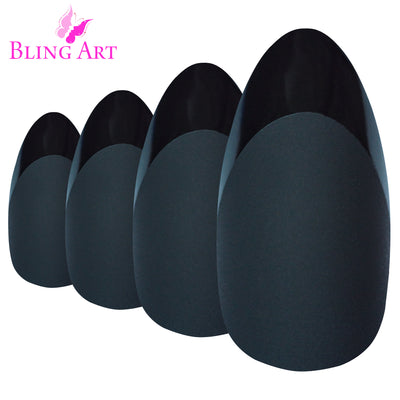 Black matte almond stiletto Bling Art press-on nails — worn-hand close-up showing the jet-black velvet matte on long pointed almond stiletto tips. Almond = Stiletto (same shape).