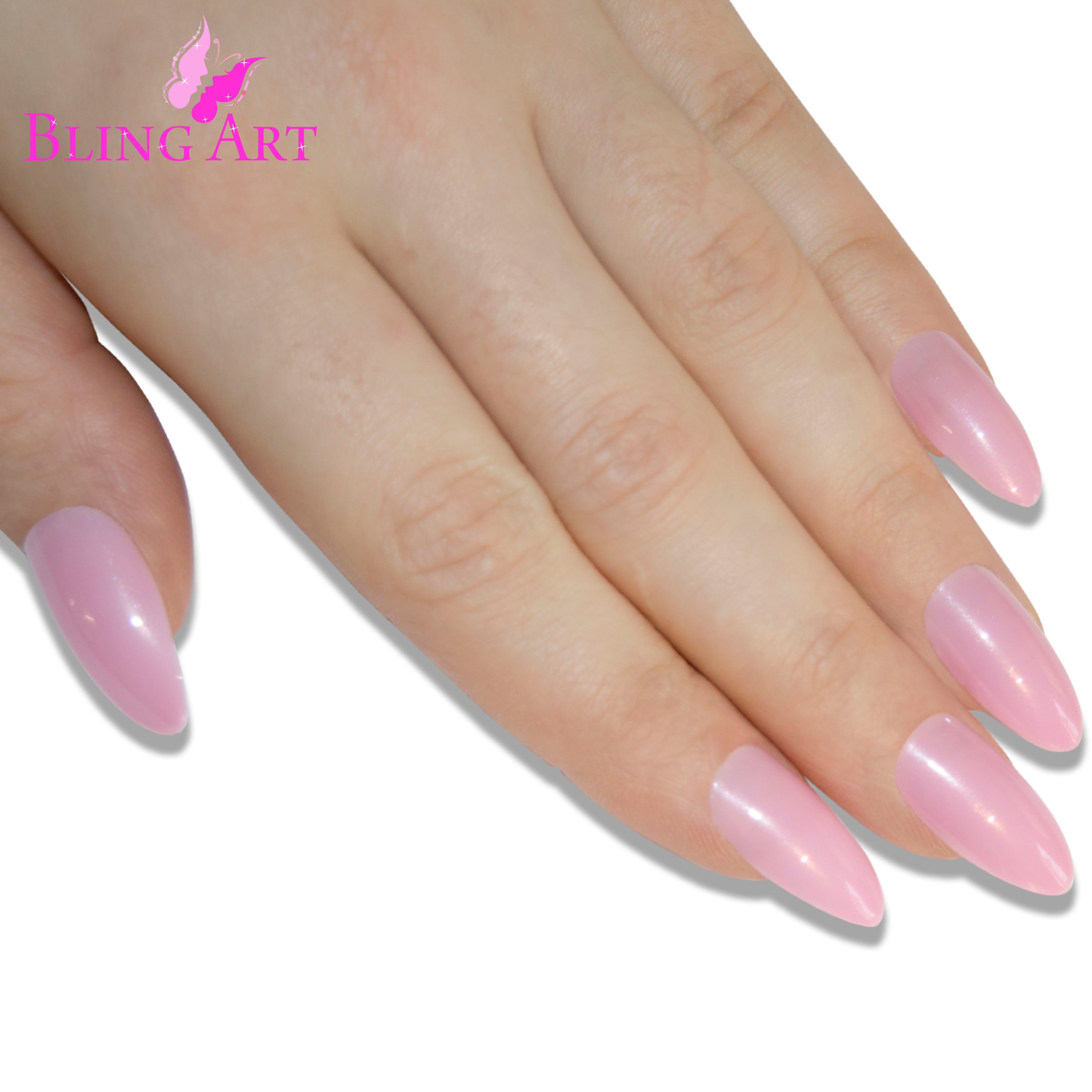 Pink polished almond stiletto Bling Art press-on nails — lifestyle context shot showing the feminine blush-pink high-shine finish.