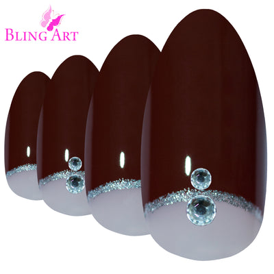 Red Brown almond stiletto Bling Art press-on nails — worn-hand close-up showing the chestnut red-brown finish on long pointed almond stiletto tips. Almond = Stiletto (same shape).