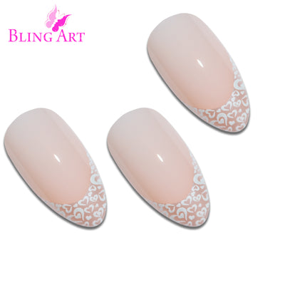 White Hearts almond stiletto long press-on false nails by Bling Art — playful pearl-white base with heart-pattern detail for Valentine's, date nights and bridal events. 24 nails, 12 sizes XS-XXL, no UV lamp. Designed in Yorkshire UK. Almond = Stiletto (same shape).