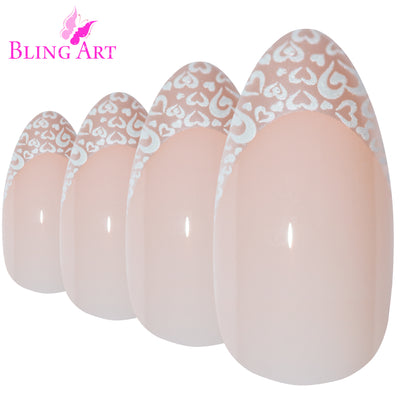 White Hearts almond stiletto long press-on false nails by Bling Art — playful pearl-white base with heart-pattern detail for Valentine's, date nights and bridal events. 24 nails, 12 sizes XS-XXL, no UV lamp. Designed in Yorkshire UK. Almond = Stiletto (same shape).