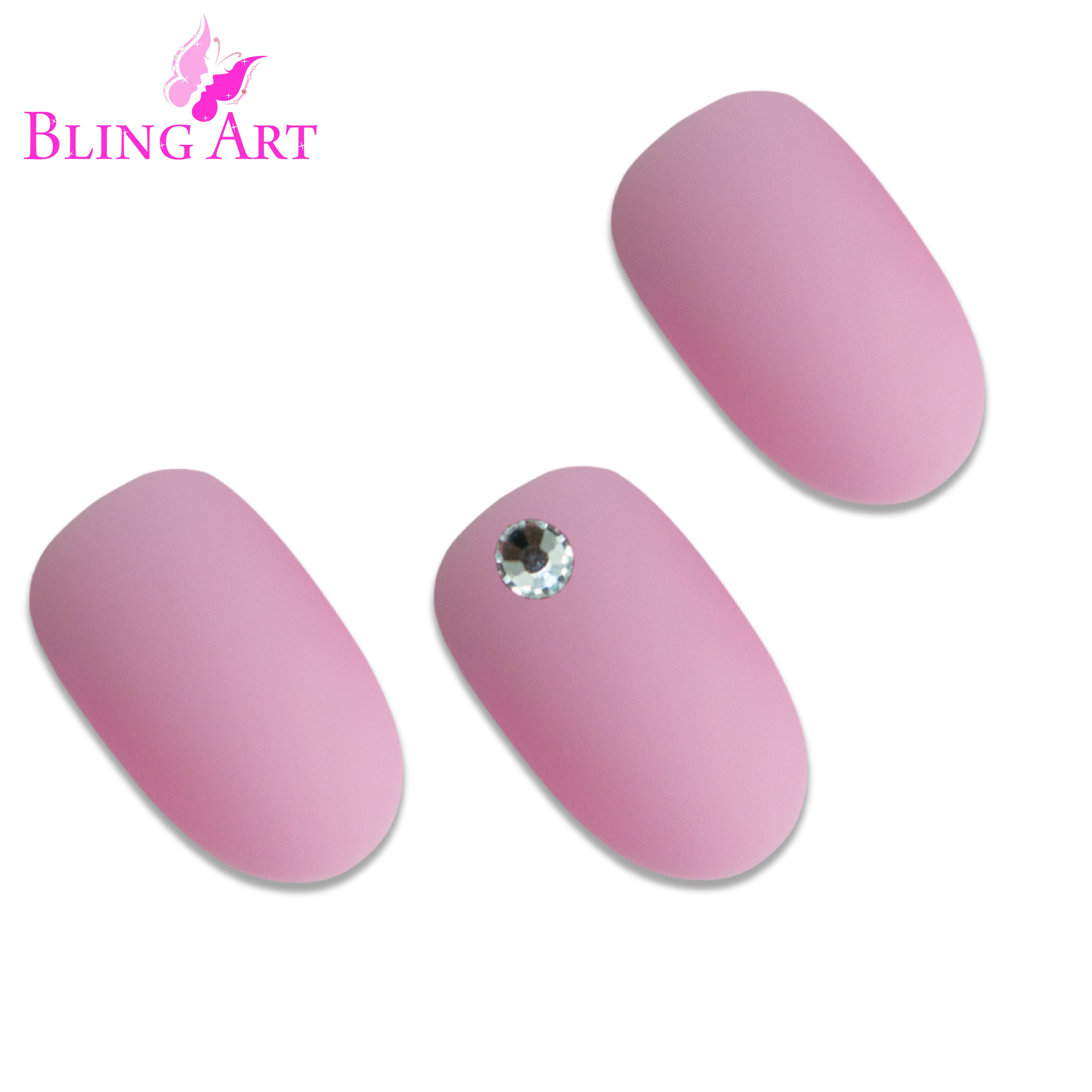 Pink matte oval Bling Art press-on nails — worn-hand close-up showing the blush-pink velvet matte on medium-length oval tips.