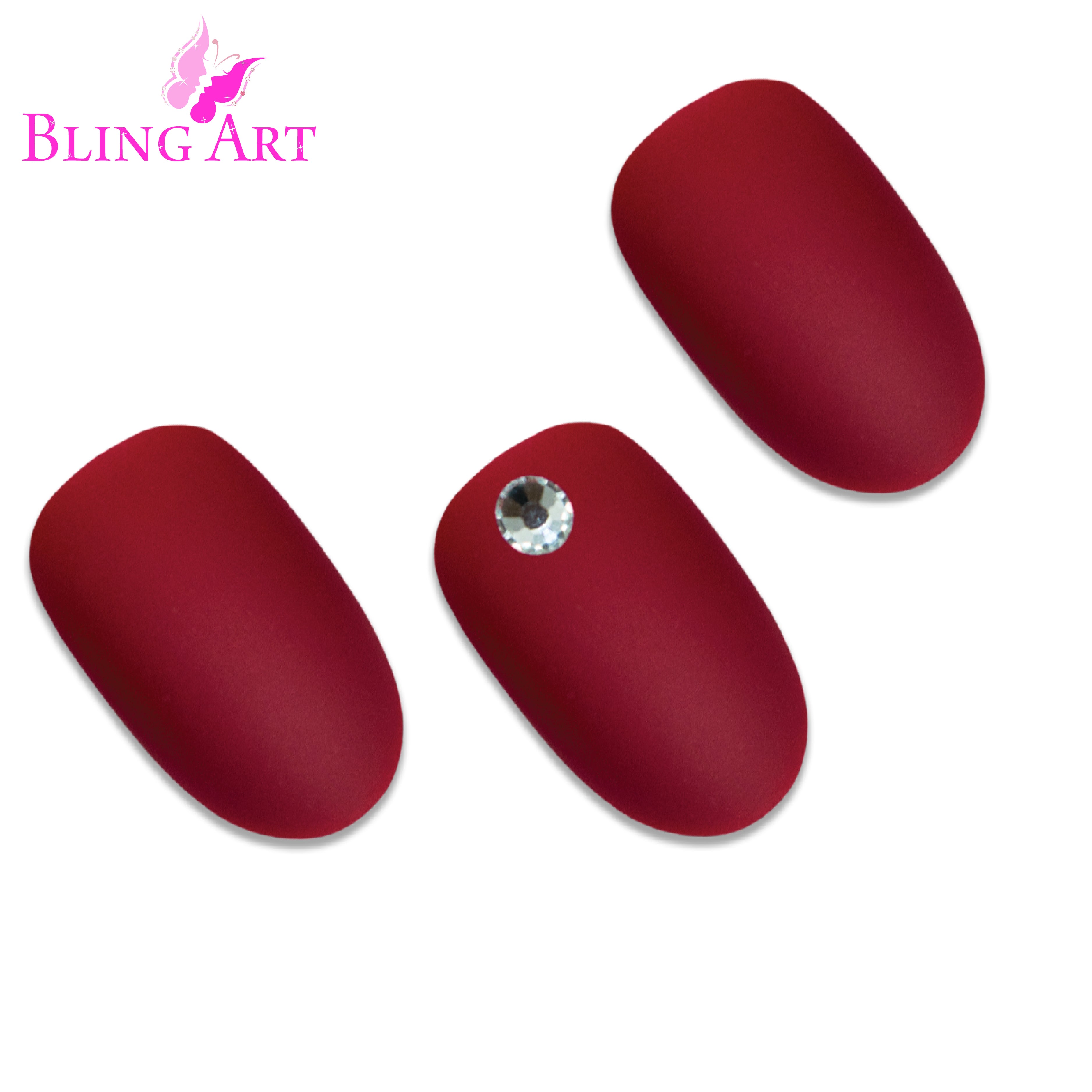 Red matte oval press-on nails by Bling Art — worn-hand close-up showing the velvet matte texture on medium-length oval tips.