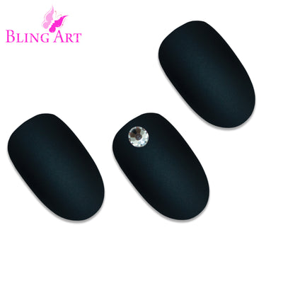Black matte oval press-on false nails by Bling Art — deep jet-black velvet matte for edgy everyday wear and modern statement looks. 24 nails, 12 sizes XS-XXL, no UV lamp. Designed in Yorkshire UK.