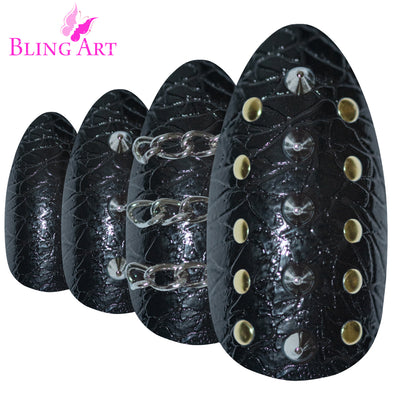 Black punk-style almond stiletto long press-on false nails by Bling Art — fierce edgy statement for parties, festivals, and bold trend-led looks · high-shine finish with punk-style design · long almond stiletto tips · 24 nails per set with adhesive · designed in Yorkshire