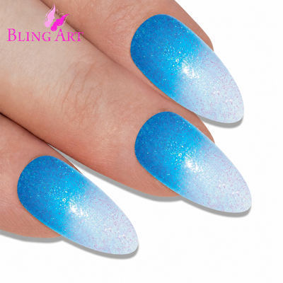 Blue gel ombre almond stiletto Bling Art press-on nails — worn-hand close-up showing the vivid blue gradient on long pointed almond stiletto tips. Almond = Stiletto (same shape).