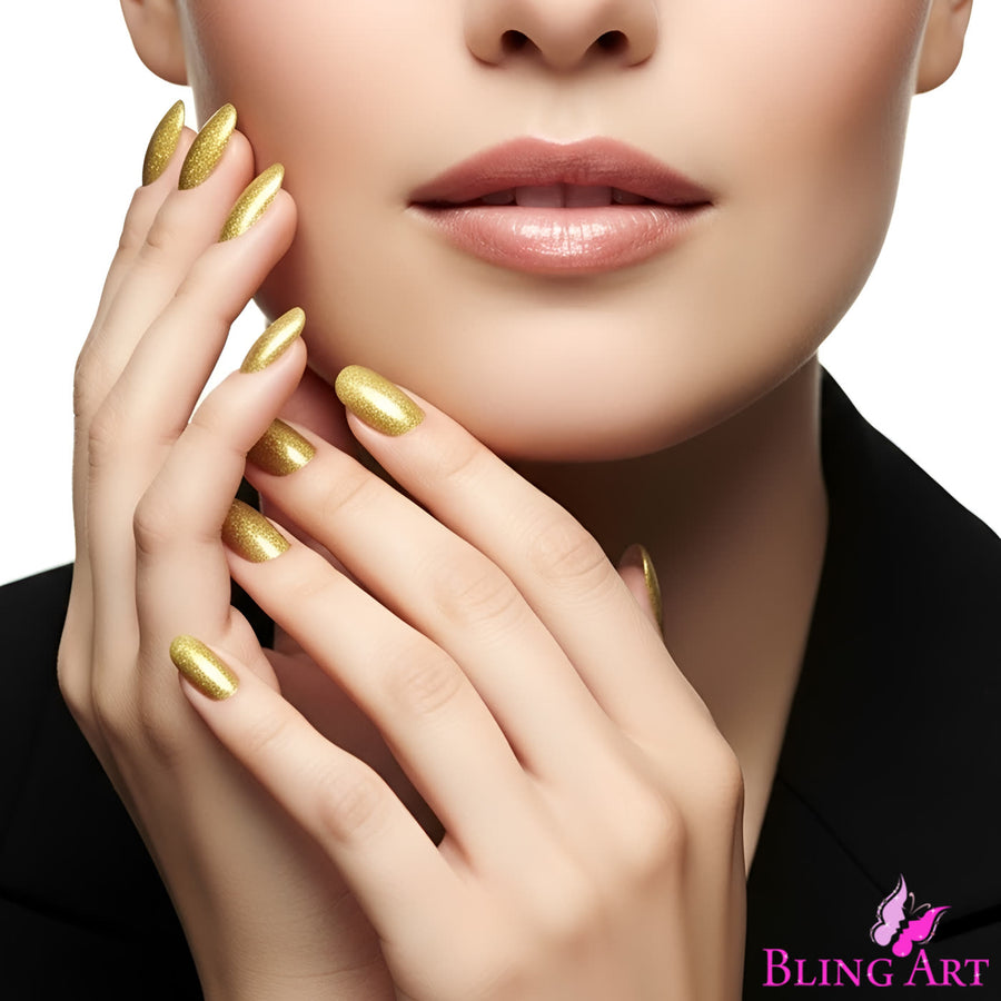 Gel Gold oval false nails by Bling Art, a warm gold glitter finish, worn by a model in a black jacket