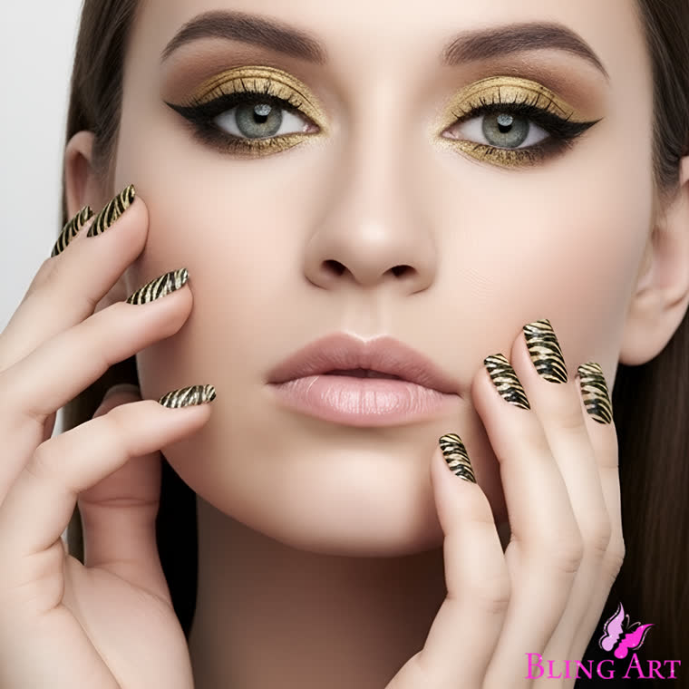 Golden Camouflage fake acrylic nails by Bling Art, black and gold animal print on a squoval tip, worn by a model with gold eyeshadow